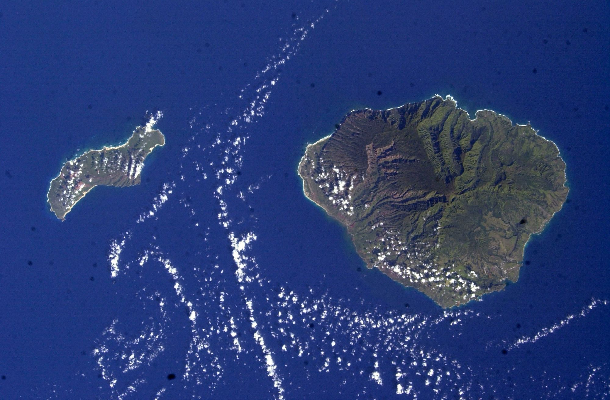 Satellite view from the International Space Station of Niʻihau, the Forbidden Island, beside the larger island of Kauaʻi.